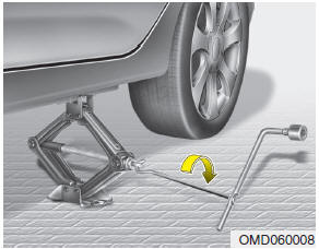 Hyundai Accent: Changing tires. 8. Insert the jack handle into the jack and turn it clockwise, raising the vehicle